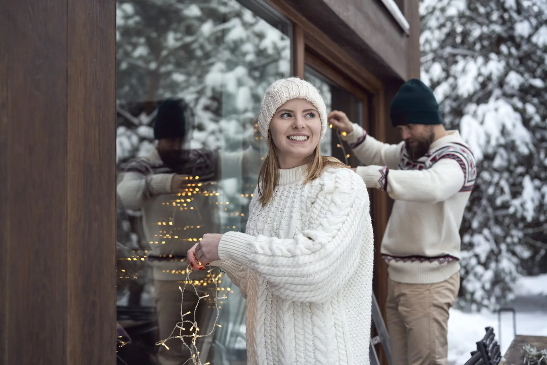 Caucasian couple decorating home for Christmas time